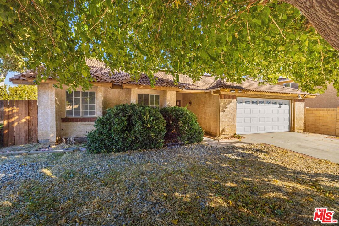 1415 Kings Road Palmdale, CA 93551 - Photo 3 of 27 a front view of a house with a garden