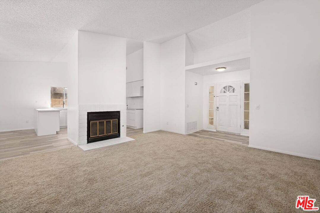 1415 Kings Road Palmdale, CA 93551 - Photo 5 of 27 a view of empty room with a fireplace