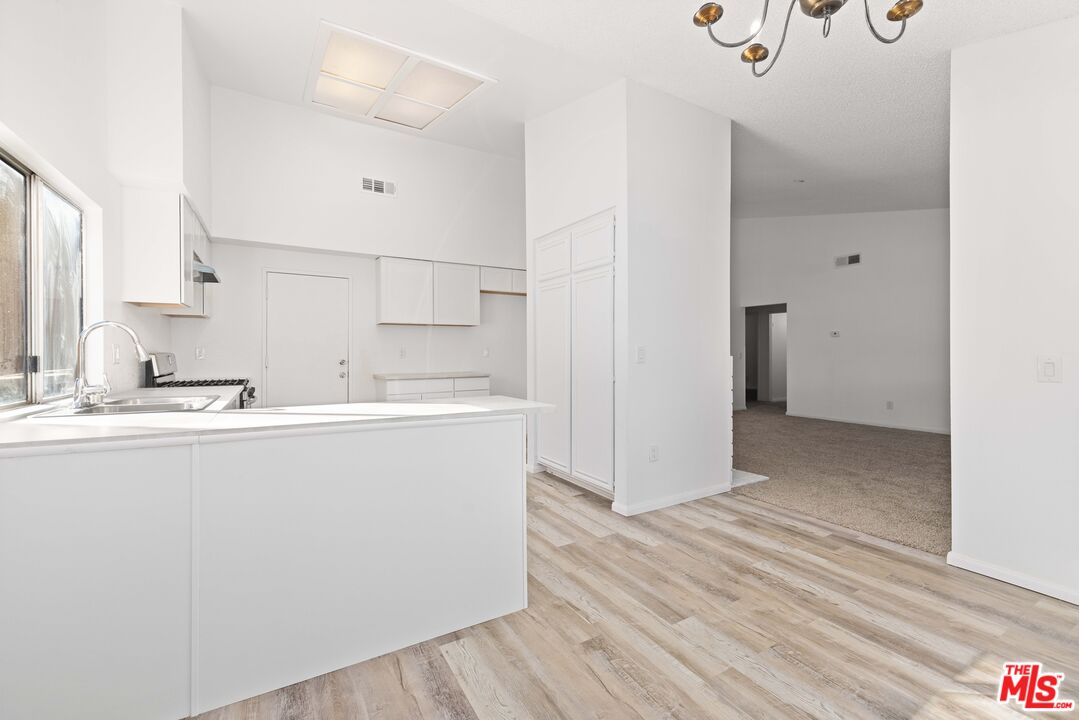 1415 Kings Road Palmdale, CA 93551 - Photo 7 of 27 a view of a kitchen with wooden floor