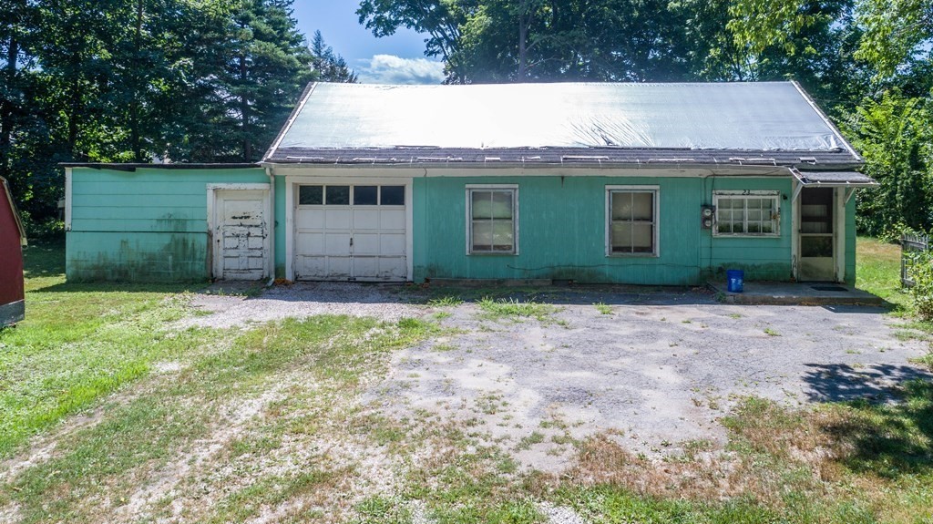 23 Bennett Lane Lancaster, MA 01523 - Photo 1 of 4 a front view of a house with a garden