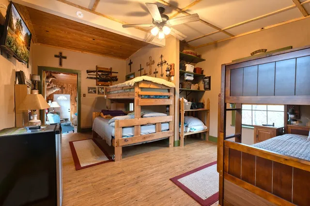 a view of living room kitchen with stainless steel appliances wooden floor and chandelier