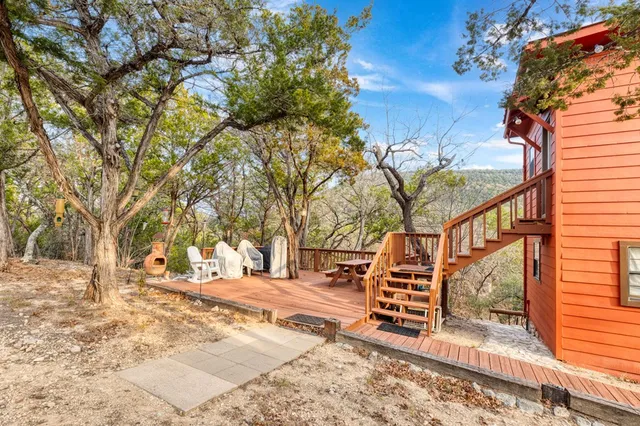 a view of road with large trees