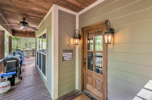 a view of a porch with wooden floor and furniture
