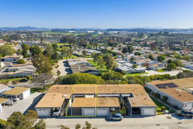 an aerial view of residential houses with city view