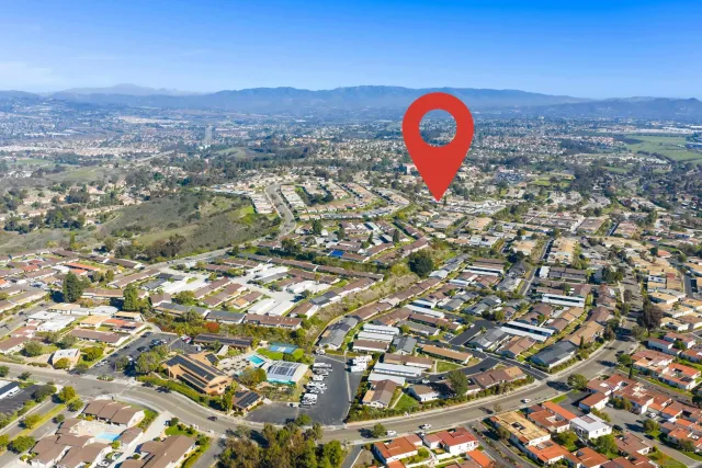 a view of a hallway view with wooden floor and a bathroom