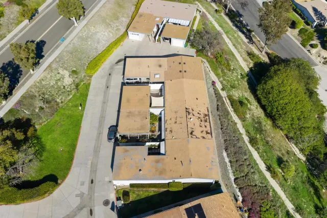 an aerial view of a residential houses with outdoor space