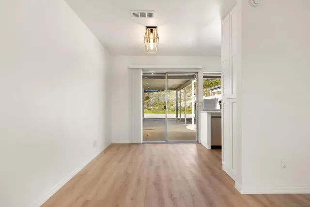 an empty room with floor to ceiling fan