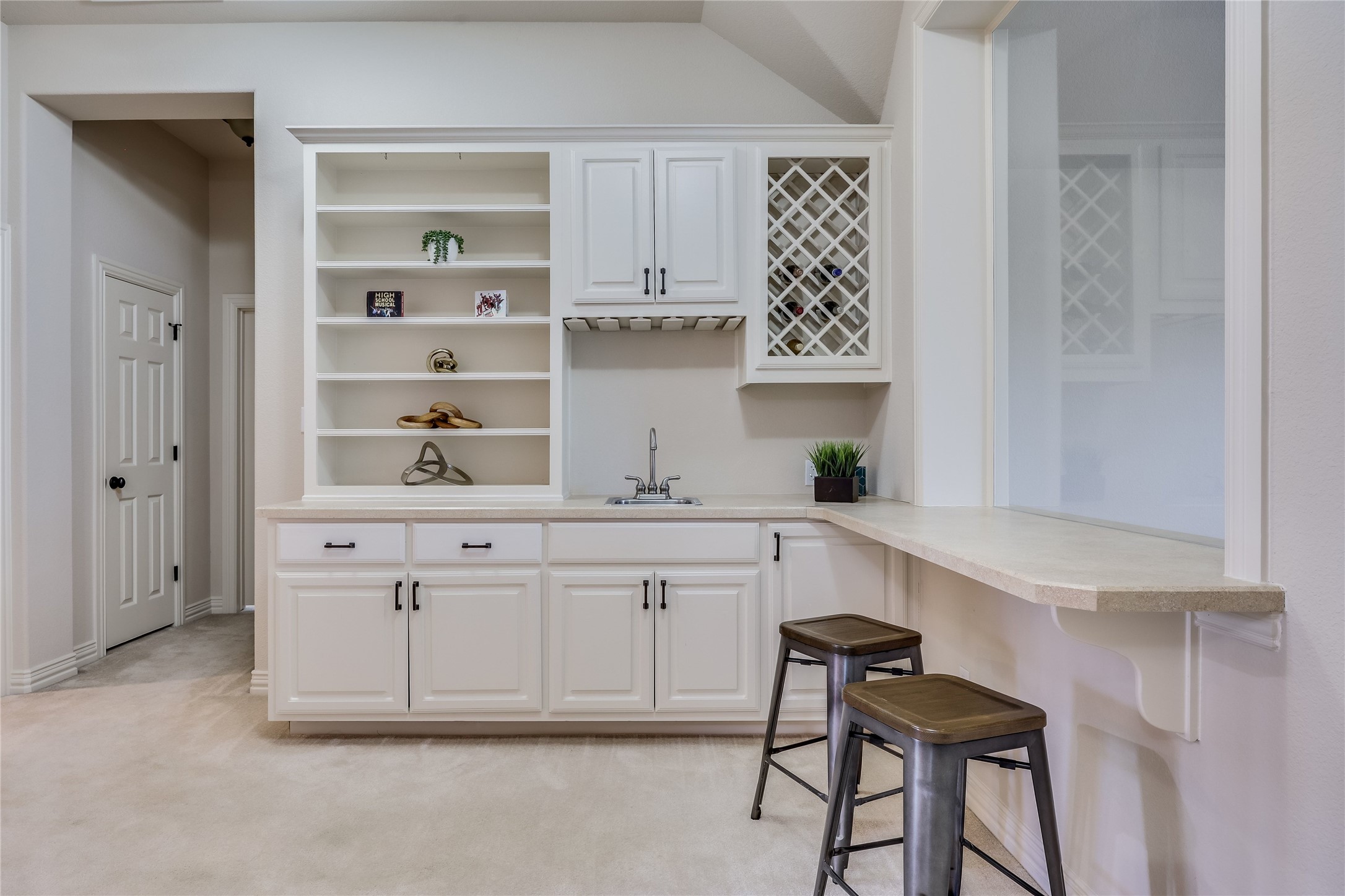 408 Ridgetop Bend Cedar Park, TX 78613 - Photo 31 of 40 A wet bar features custom cabinetry, a built-in wine rack, and a pass-through counter.