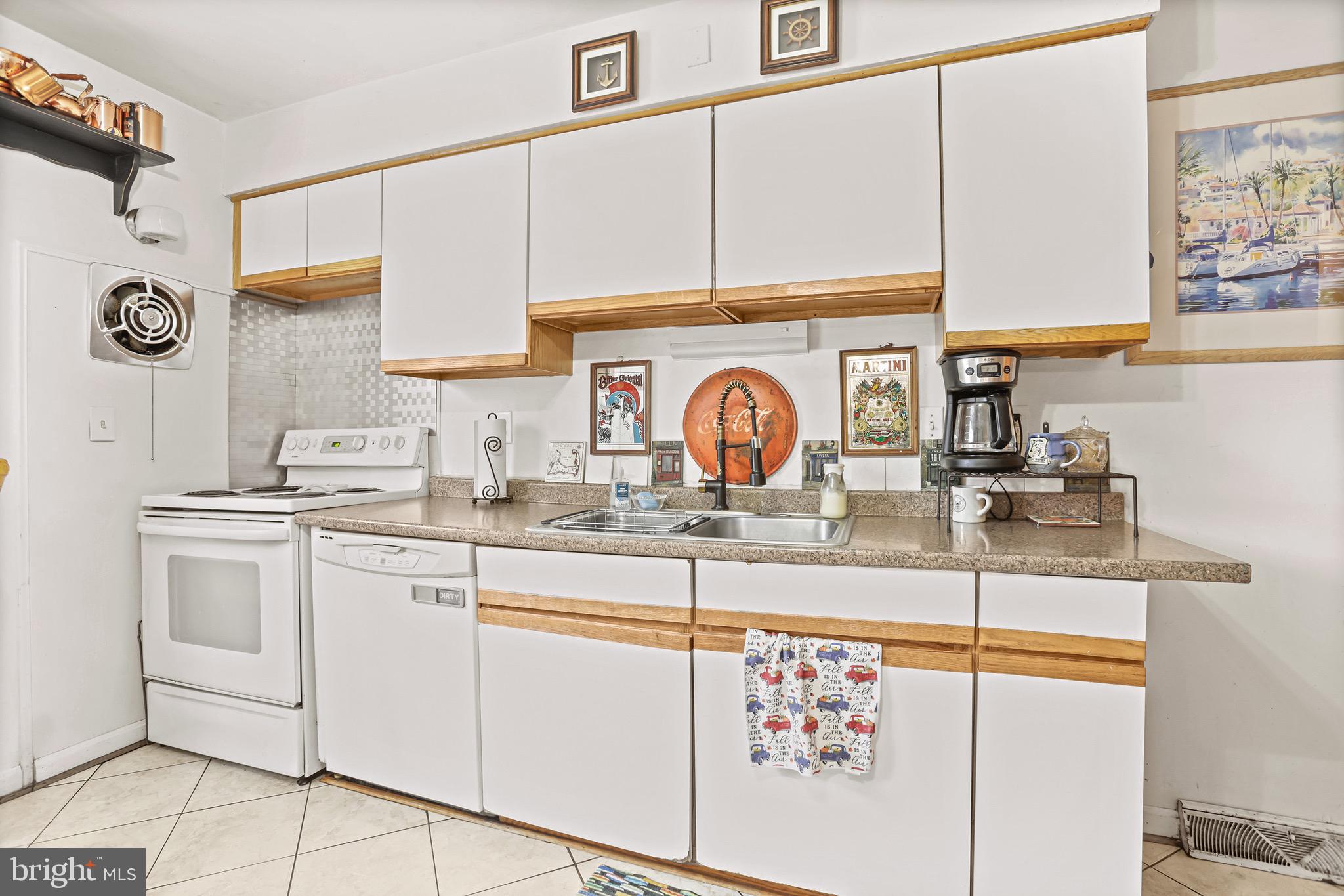 3504 Wakefield Street Colonial Beach, VA 22443 - Photo 16 of 53 a kitchen with stainless steel appliances granite countertop a sink and a white cabinets