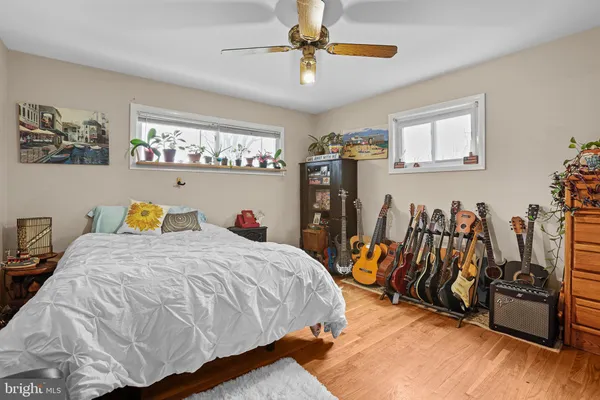 a bedroom with a large bed and a flat tv screen on dresser