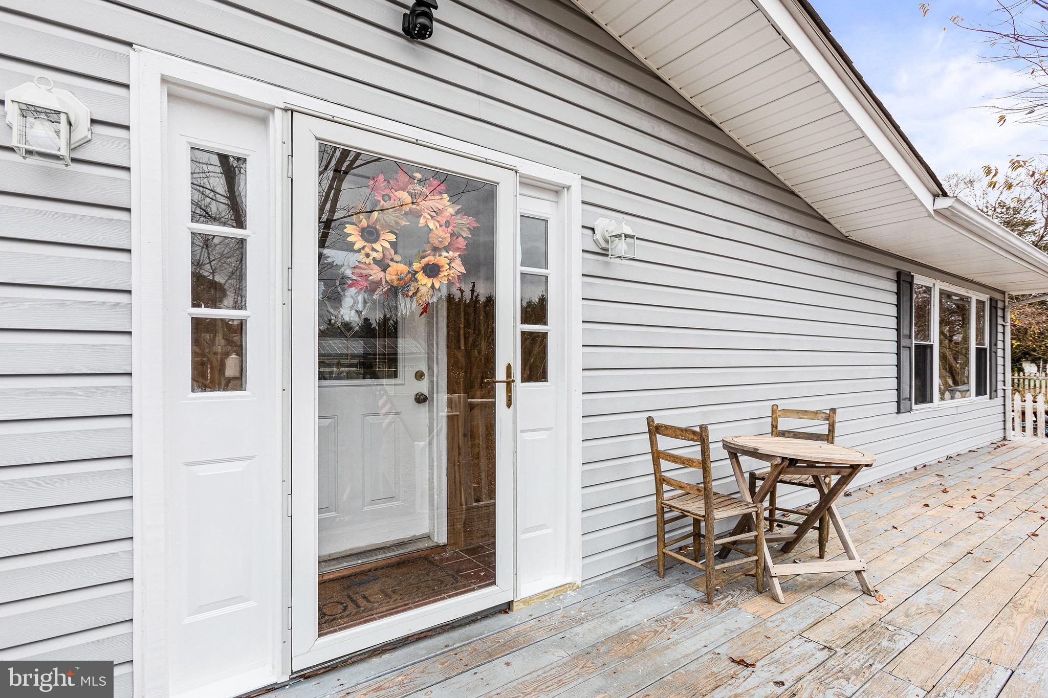 3504 Wakefield Street Colonial Beach, VA 22443 - Photo 5 of 53 a view of a patio with table and chairs with wooden floor and fence
