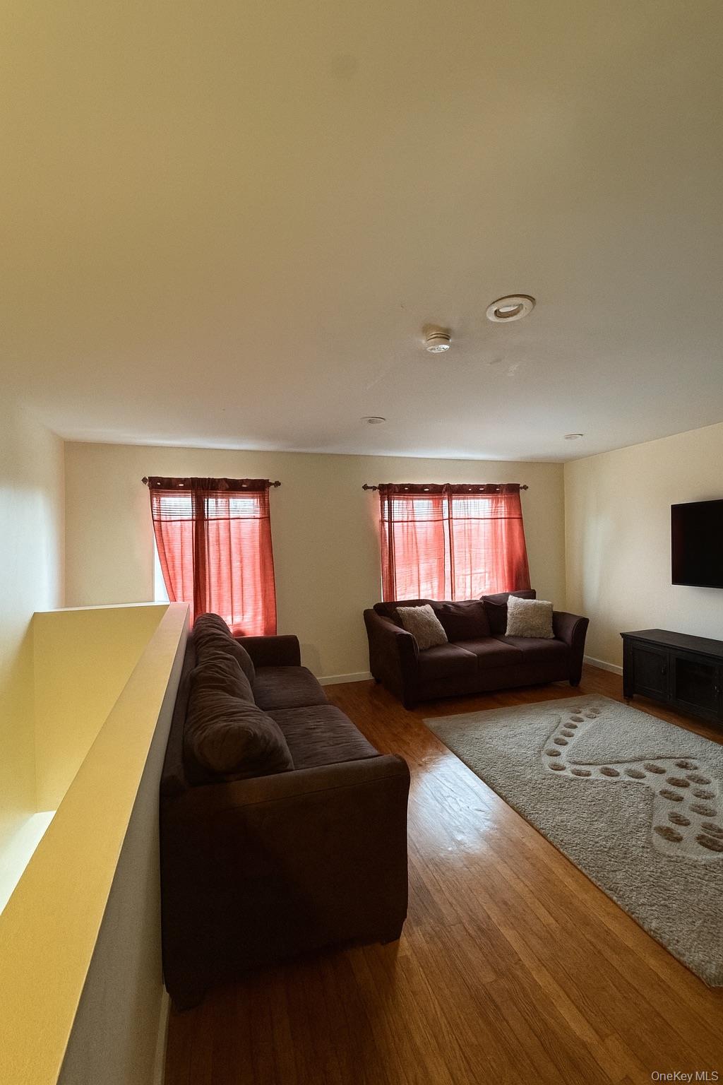 472 Sutter Avenue Brooklyn, NY 11207 - Photo 2 of 8 a living room with furniture and a window