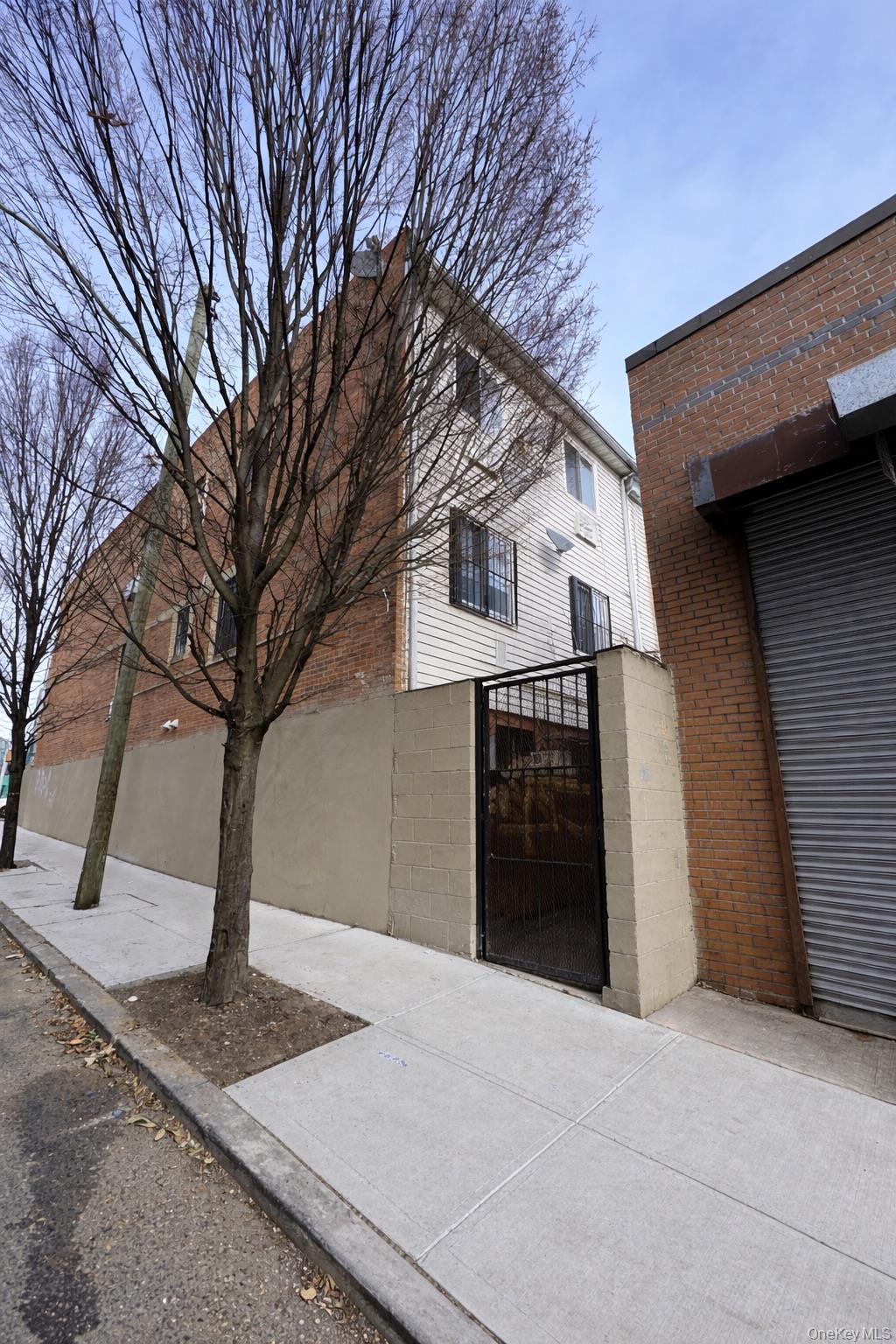 472 Sutter Avenue Brooklyn, NY 11207 - Photo 8 of 8 a front view of a house with a yard