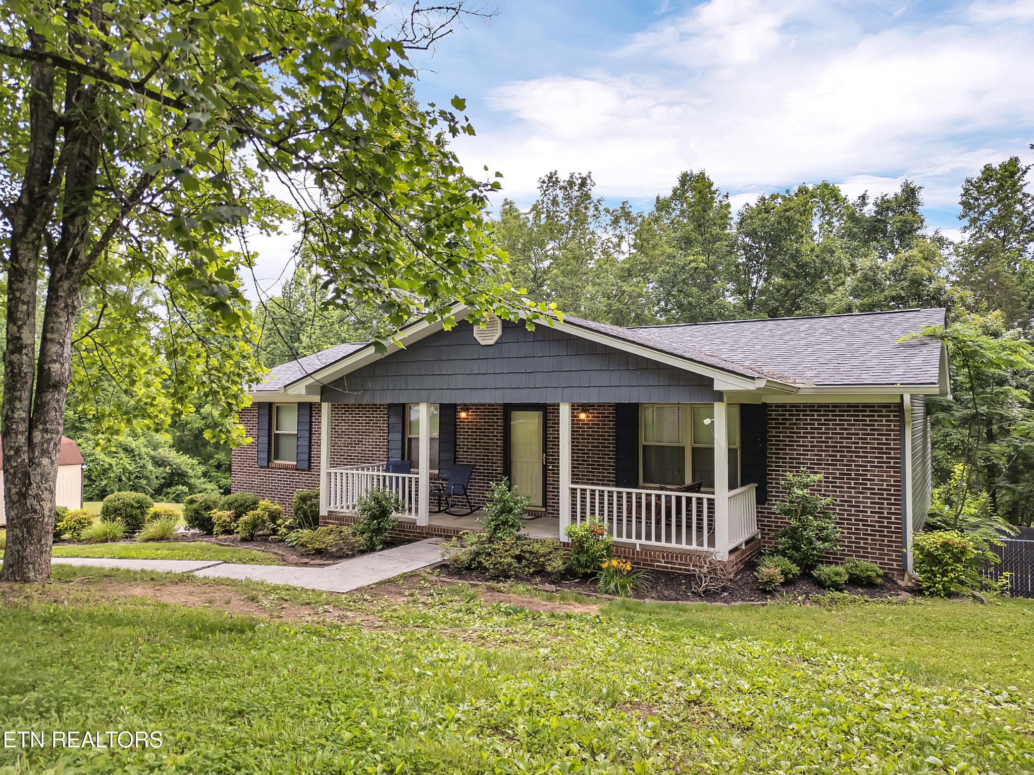 3342 Shagbark Road Powell, TN 37849 - Photo 16 of 32 a front view of a house with a garden