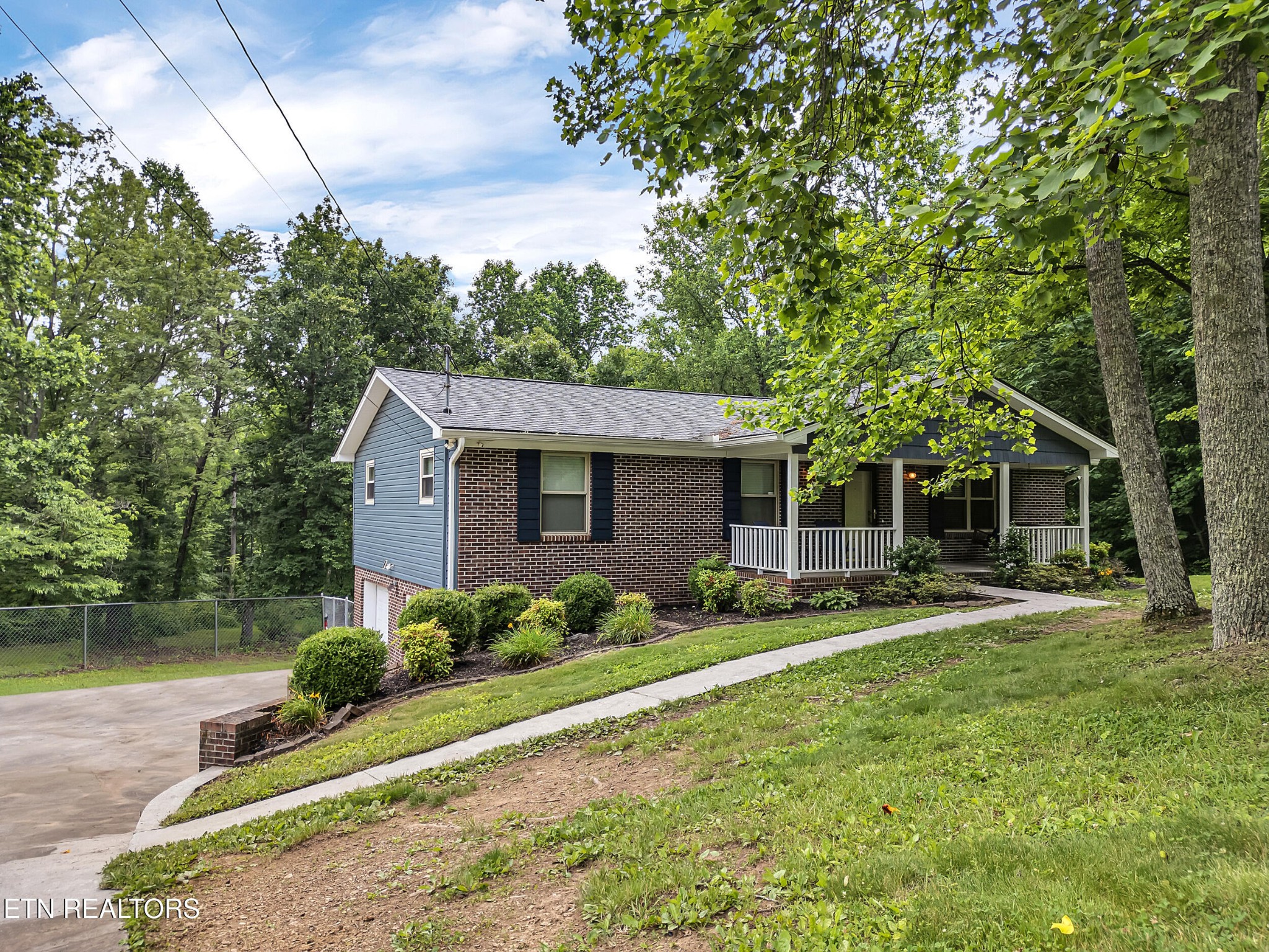 3342 Shagbark Road Powell, TN 37849 - Photo 2 of 32 a front view of a house with garden