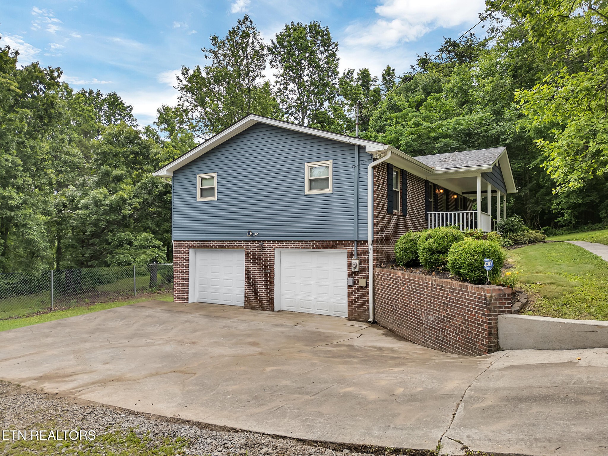 3342 Shagbark Road Powell, TN 37849 - Photo 3 of 32 front view of house with a yard and trees all around