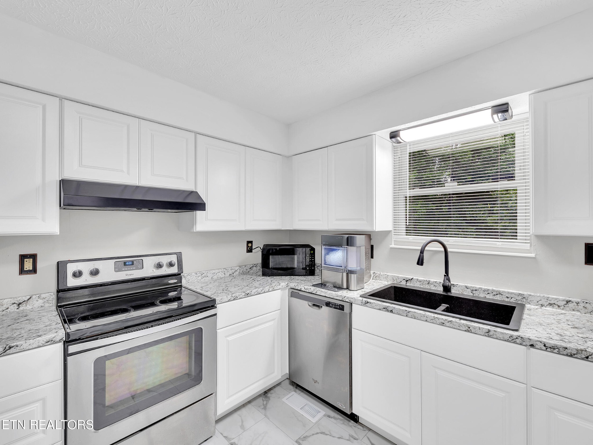 3342 Shagbark Road Powell, TN 37849 - Photo 10 of 32 a kitchen with appliances a sink and cabinets