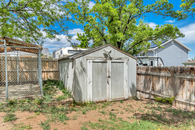 843 Deer Flat Road Tooele, UT 84074 - Photo 27 of 27 Storage shed with double doors and an exterior light fixture