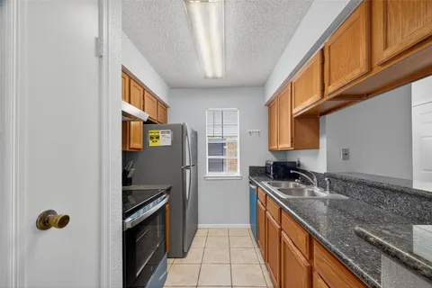 a kitchen with stainless steel appliances granite countertop a stove and a sink
