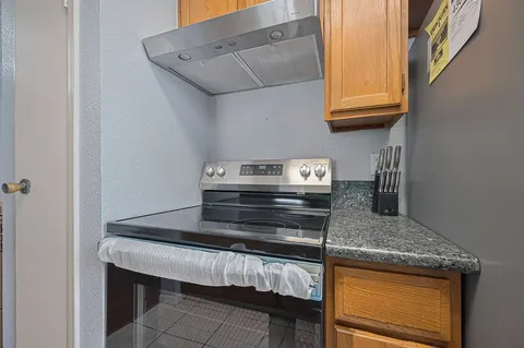 a kitchen with a stove and a refrigerator