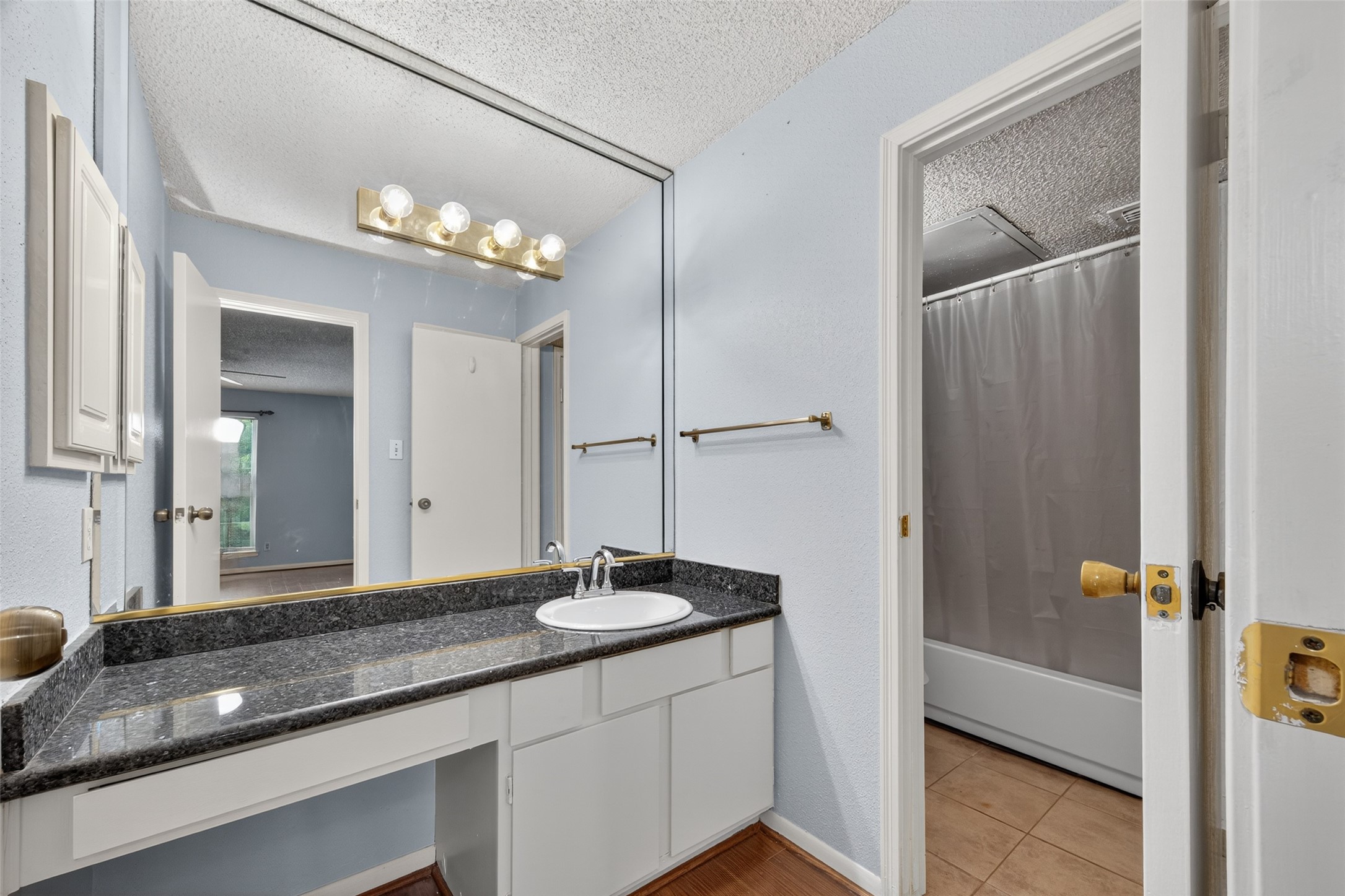 3100 Jeanetta Street, Unit 1104 Houston, TX 77063 - Photo 17 of 25 a bathroom with a double vanity sink and a mirror
