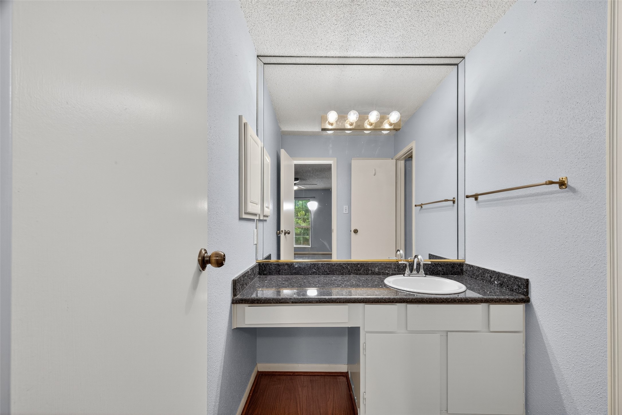 3100 Jeanetta Street, Unit 1104 Houston, TX 77063 - Photo 18 of 25 a bathroom with a sink and a mirror