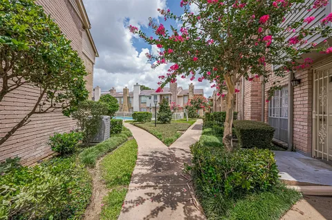 a view of swimming pool with outdoor seating and plants