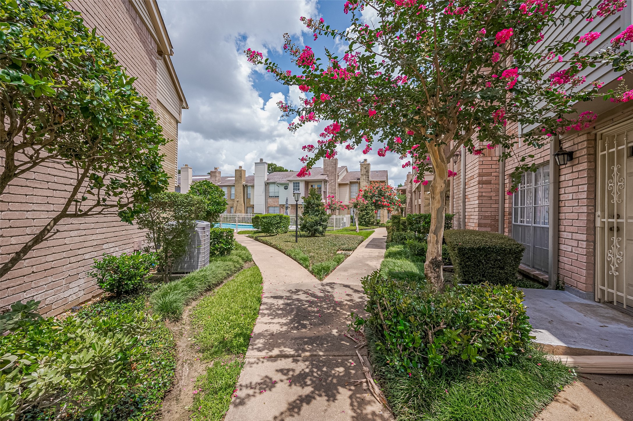 3100 Jeanetta Street, Unit 1104 Houston, TX 77063 - Photo 4 of 25 a view of a garden with flowers and trees