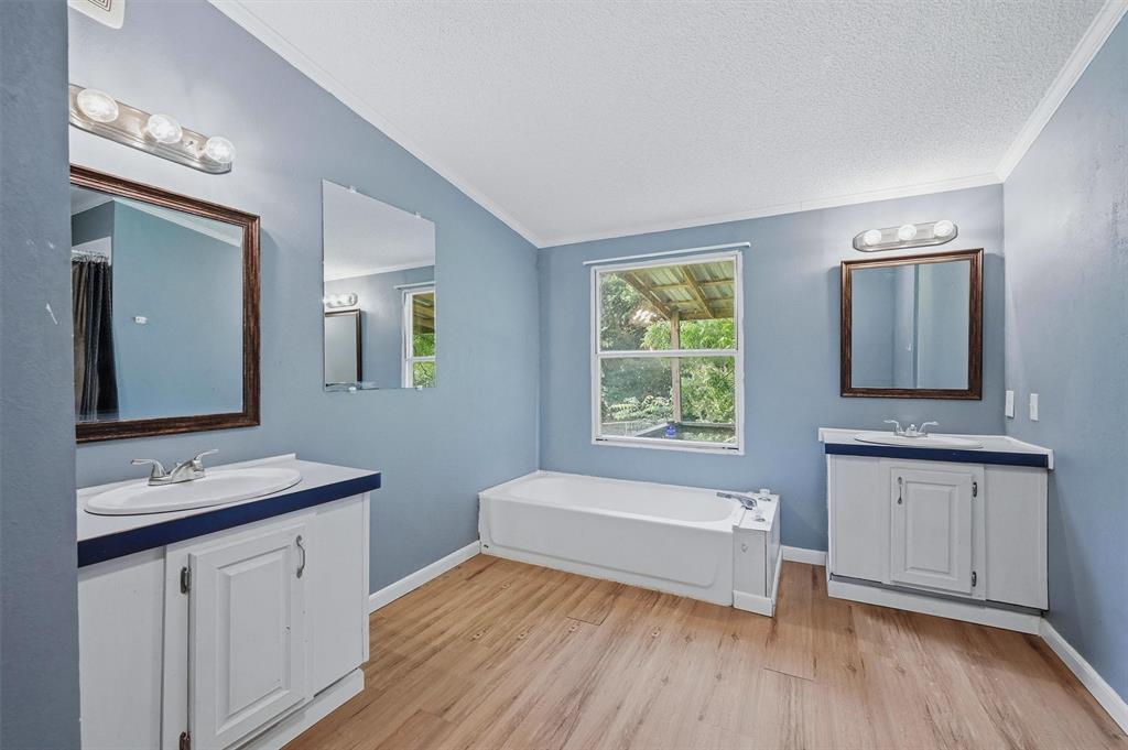 150 Gilbreath Road Sadler, TX 76264 - Photo 27 of 34 a bathroom with a sink a mirror and a bathtub