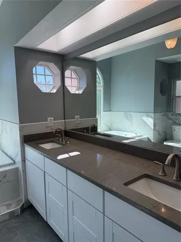 a bathroom with a glass shower door