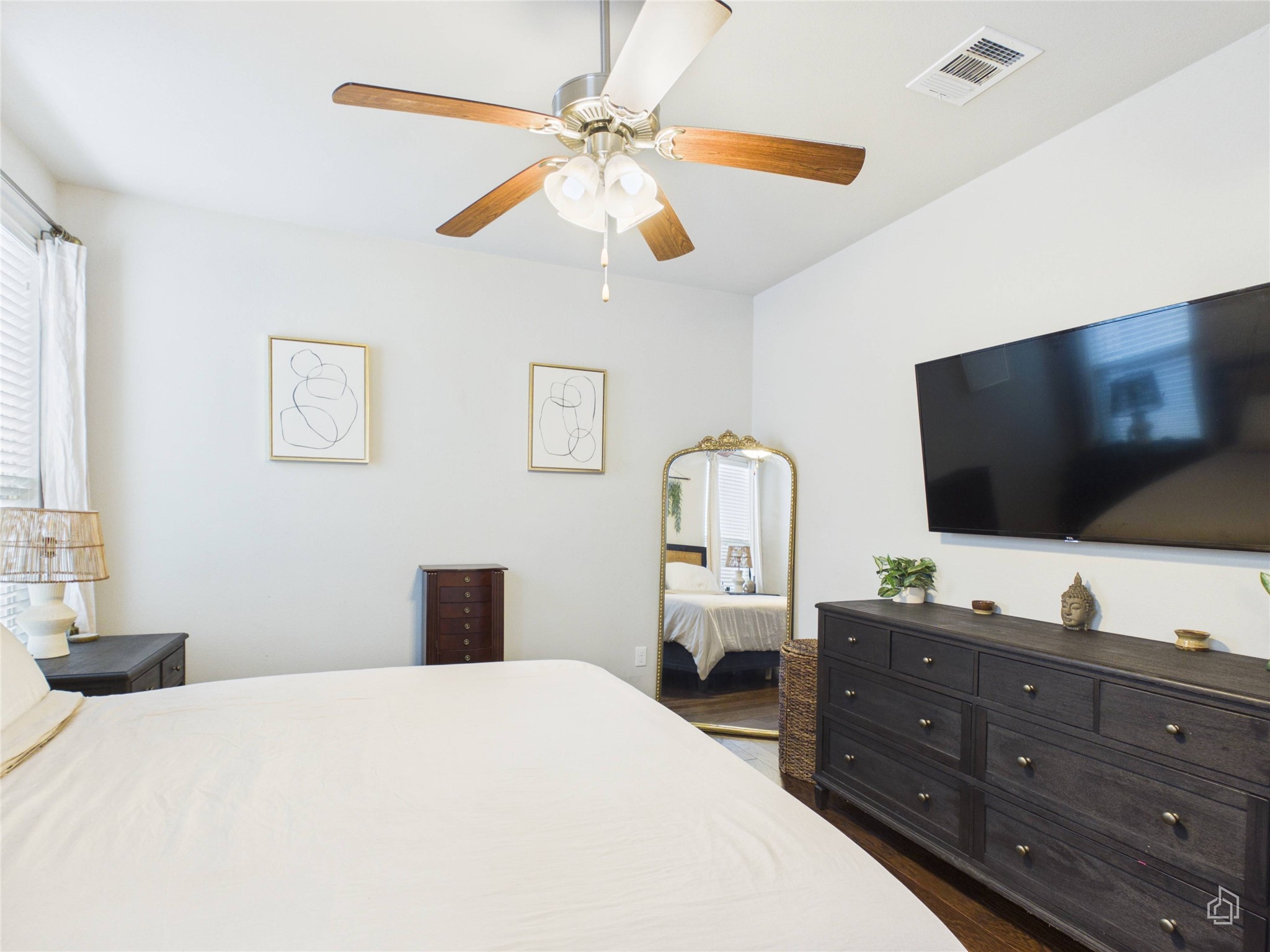 9310 Tanager Way Austin, TX 78748 - Photo 9 of 32 Well-lit sleeping quarters provide a peaceful retreat with hardwood floors and a ceiling fan for comfort.