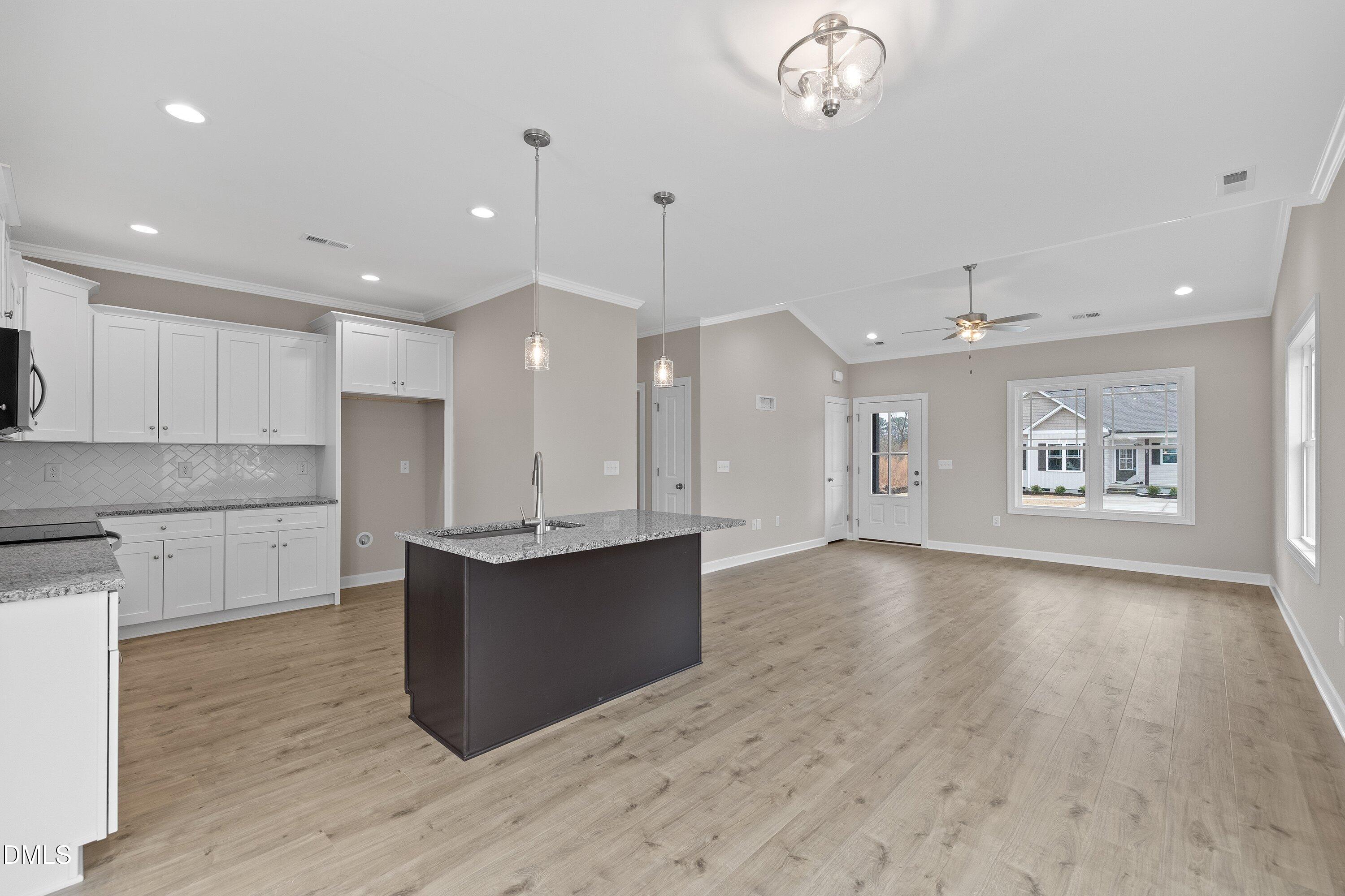 926 Micro Road West Selma, NC 27576 - Photo 18 of 41 a view of kitchen with cabinets and wooden floor