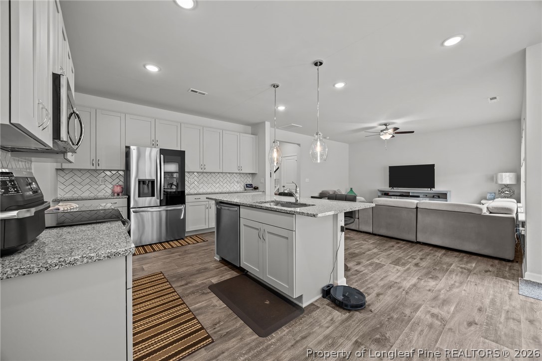 334 Beacon Hl Road Lillington, NC 27546 - Photo 14 of 49 a large white kitchen with a large window and stainless steel appliances