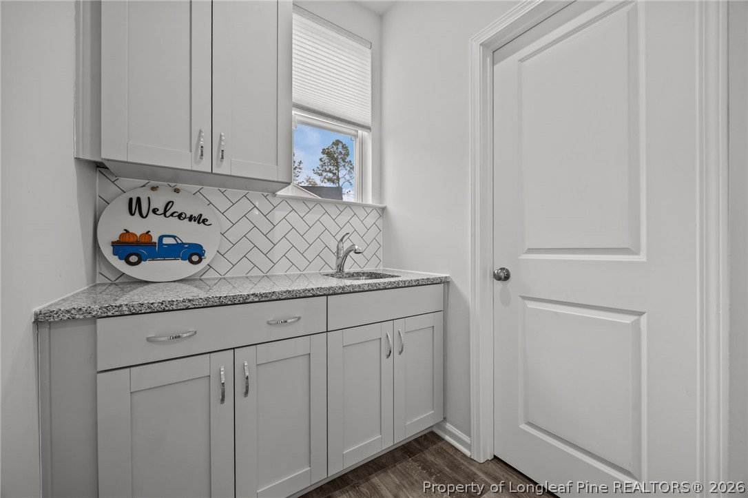 334 Beacon Hl Road Lillington, NC 27546 - Photo 16 of 49 a kitchen with granite countertop white cabinets and sink
