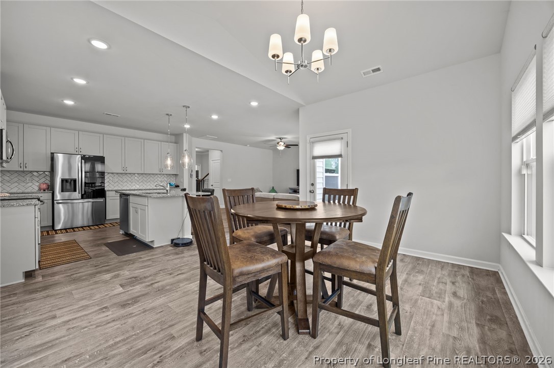 334 Beacon Hl Road Lillington, NC 27546 - Photo 18 of 49 a view of a dining room with furniture and wooden floor