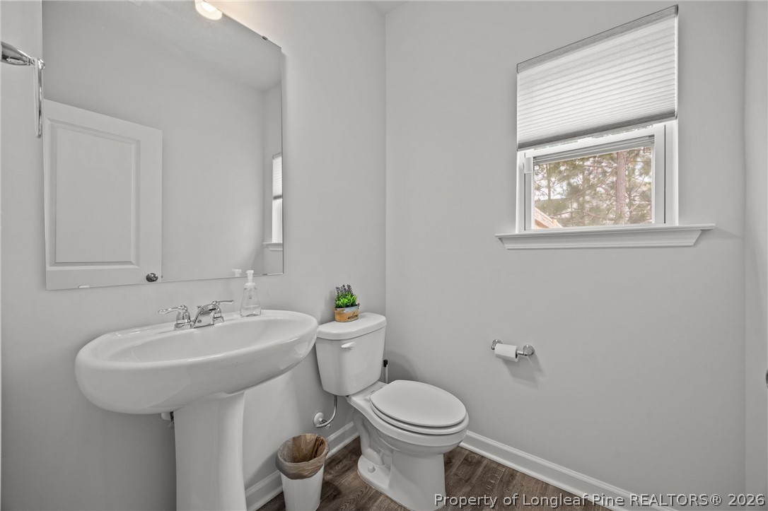 334 Beacon Hl Road Lillington, NC 27546 - Photo 19 of 49 a bathroom with a toilet sink and mirror