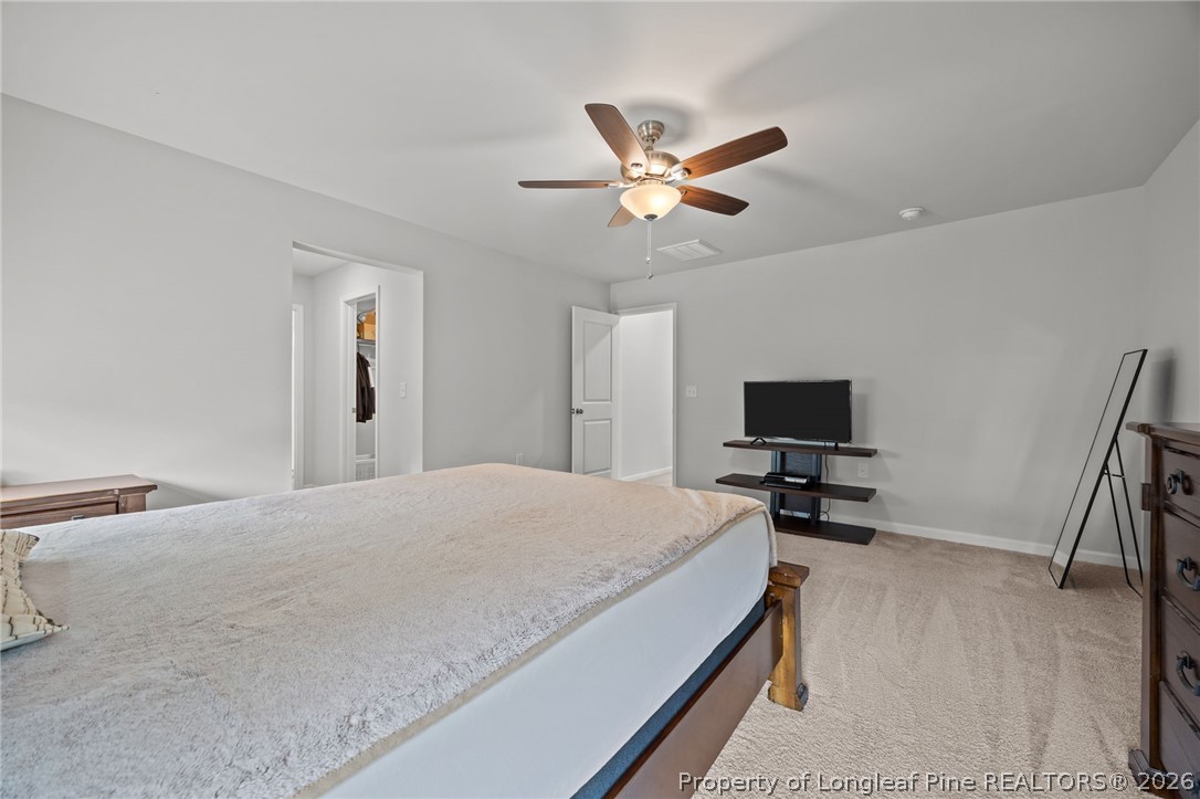 334 Beacon Hl Road Lillington, NC 27546 - Photo 22 of 49 a bedroom with a bed and a flat screen tv