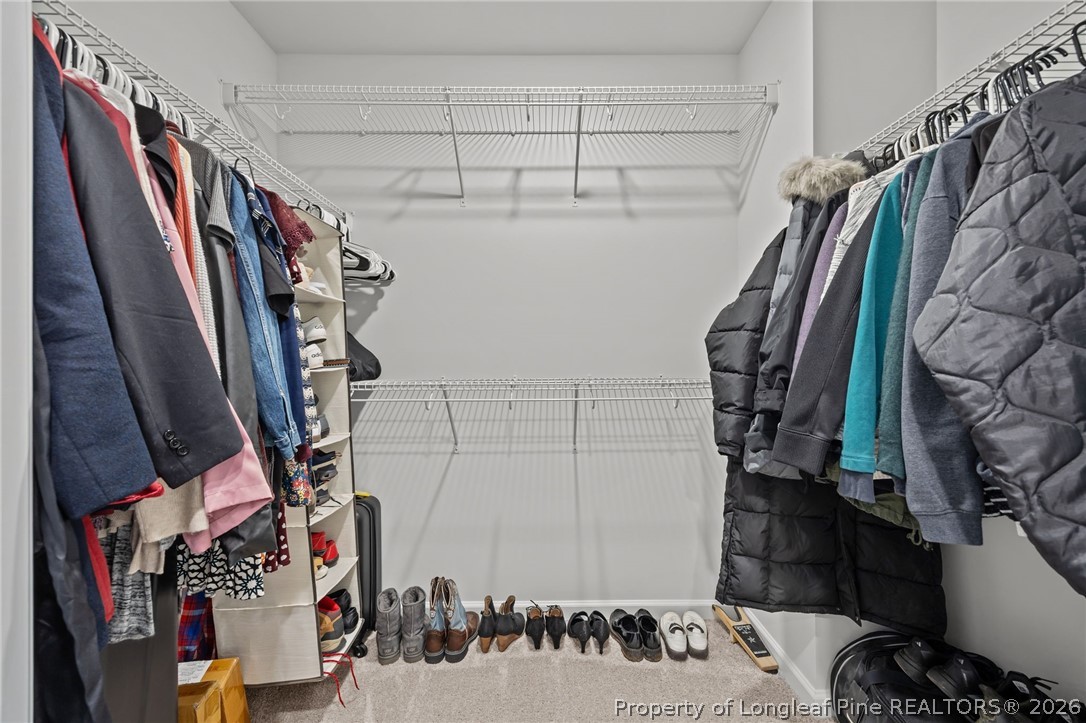 334 Beacon Hl Road Lillington, NC 27546 - Photo 23 of 49 a view of walk in closet with clothes and shoes