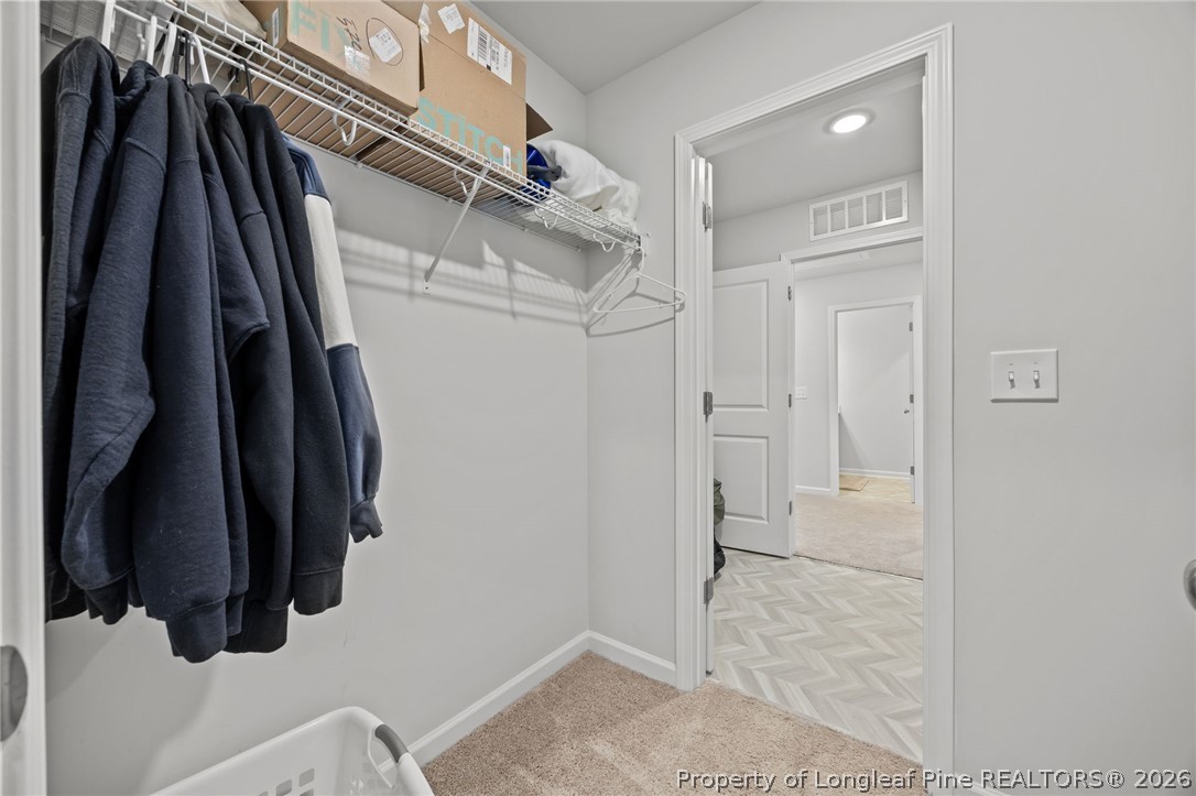 334 Beacon Hl Road Lillington, NC 27546 - Photo 24 of 49 a view of walk in closet with clothes and shoes