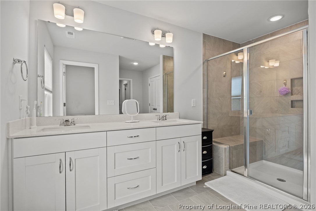 334 Beacon Hl Road Lillington, NC 27546 - Photo 25 of 49 a bathroom with a shower sink and mirror