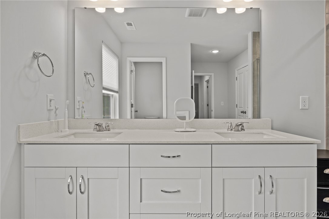 334 Beacon Hl Road Lillington, NC 27546 - Photo 26 of 49 a bathroom with double sink and a mirror