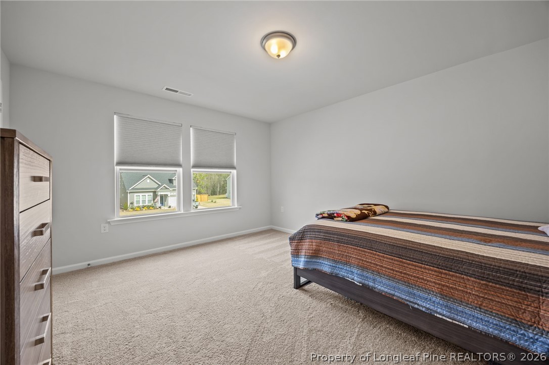 334 Beacon Hl Road Lillington, NC 27546 - Photo 27 of 49 a room with a bed and a window