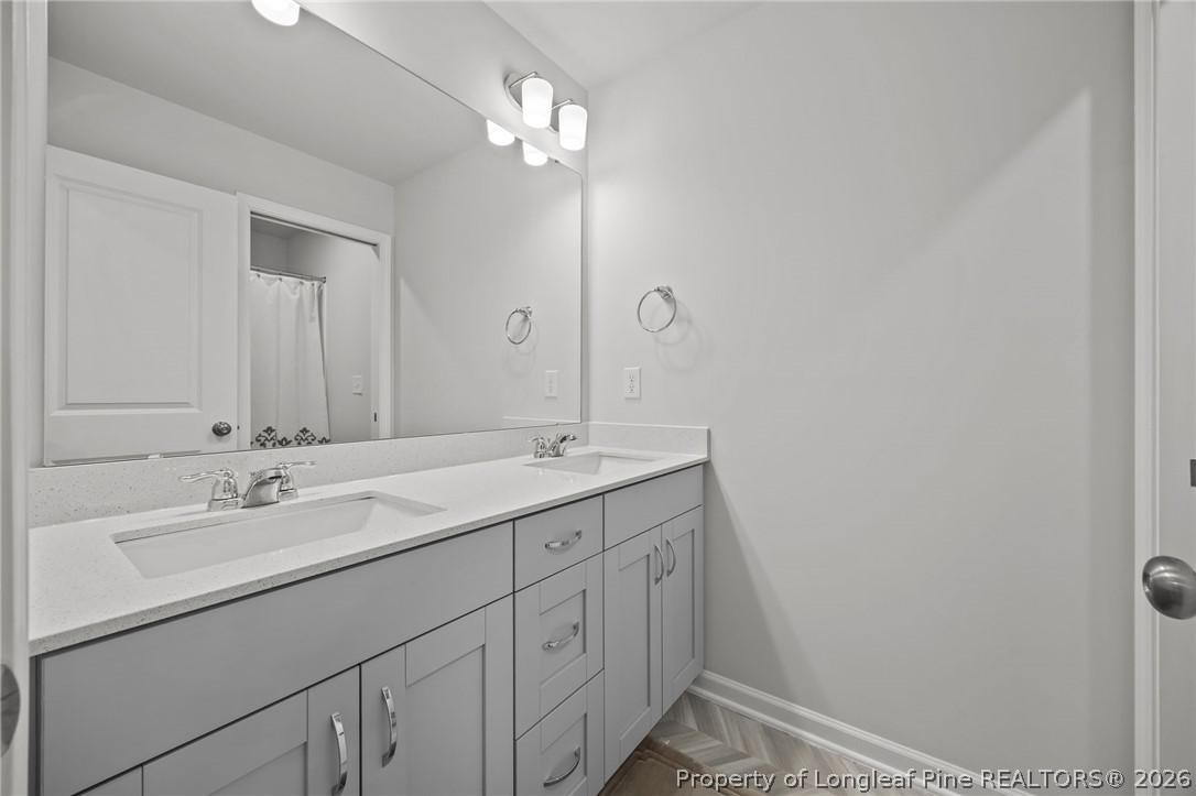 334 Beacon Hl Road Lillington, NC 27546 - Photo 29 of 49 a bathroom with a sink a light fixture and a mirror
