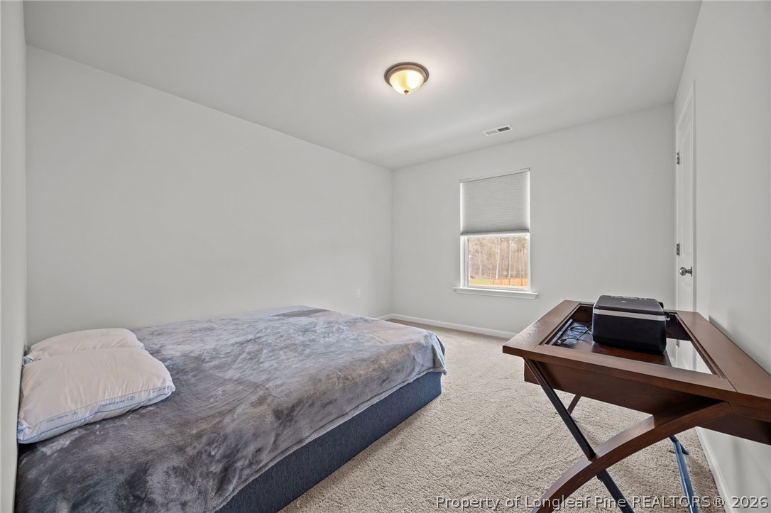 334 Beacon Hl Road Lillington, NC 27546 - Photo 30 of 49 a bedroom with a bed and a window