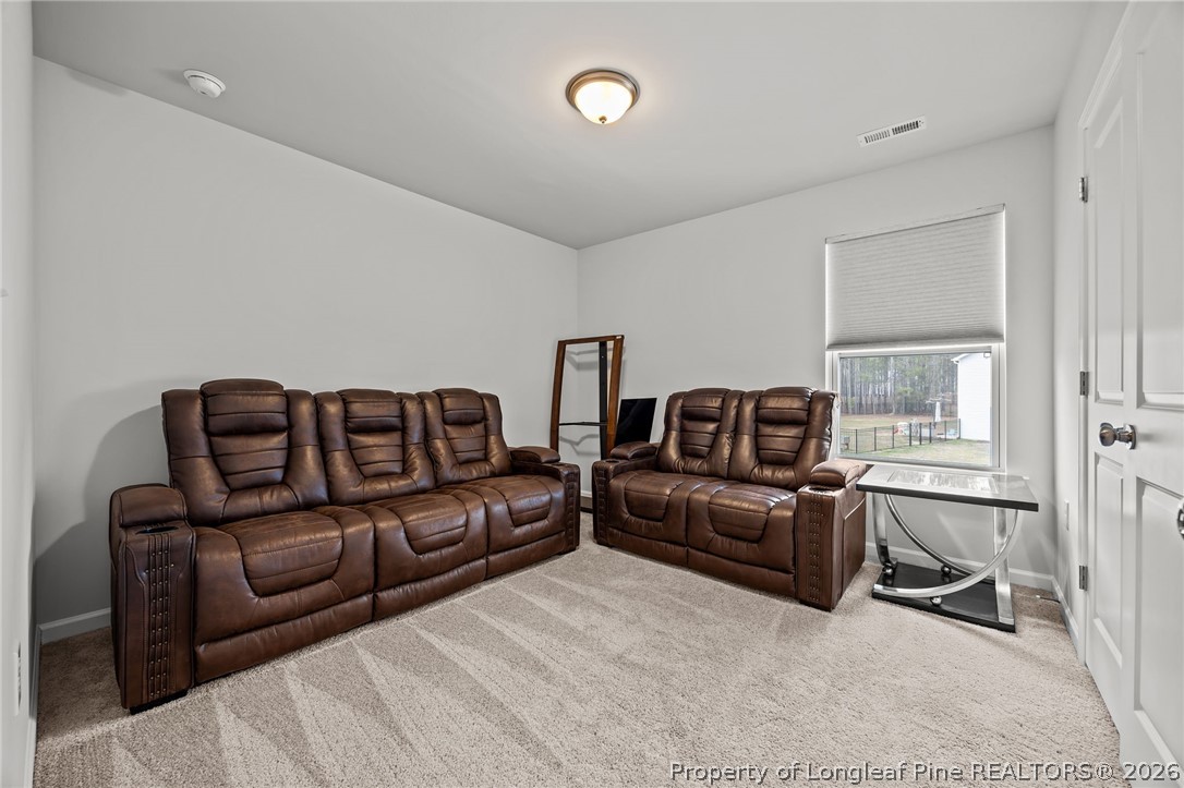 334 Beacon Hl Road Lillington, NC 27546 - Photo 31 of 49 a living room with a couch and a window