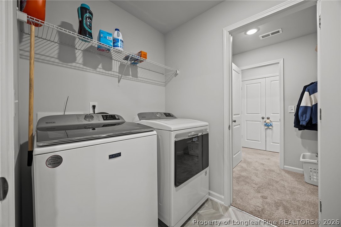 334 Beacon Hl Road Lillington, NC 27546 - Photo 32 of 49 a view of a storage and utility room with washer and dryer