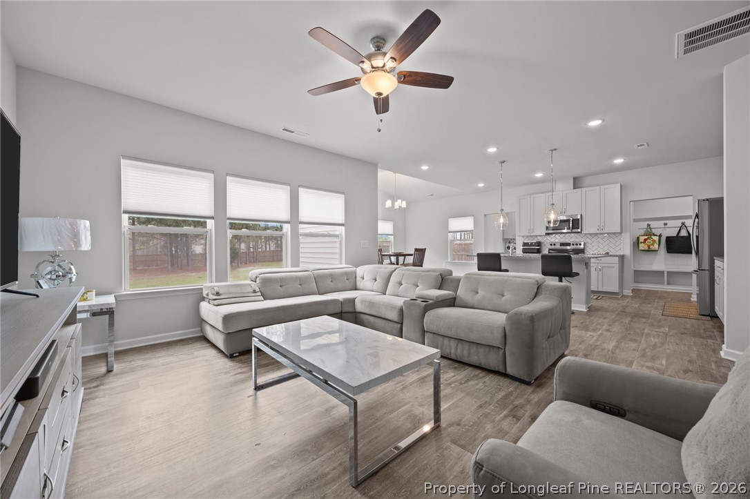 334 Beacon Hl Road Lillington, NC 27546 - Photo 9 of 49 a living room with furniture and a large window with kitchen view