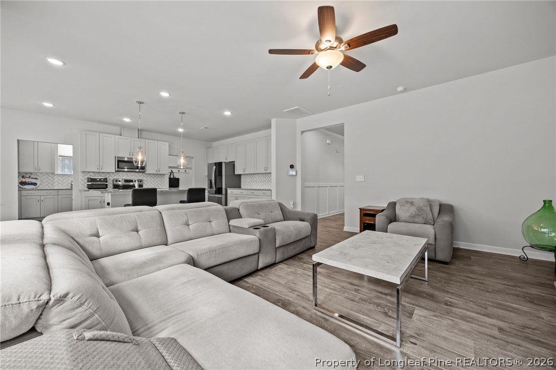 334 Beacon Hl Road Lillington, NC 27546 - Photo 10 of 49 a living room with furniture kitchen view and a chandelier