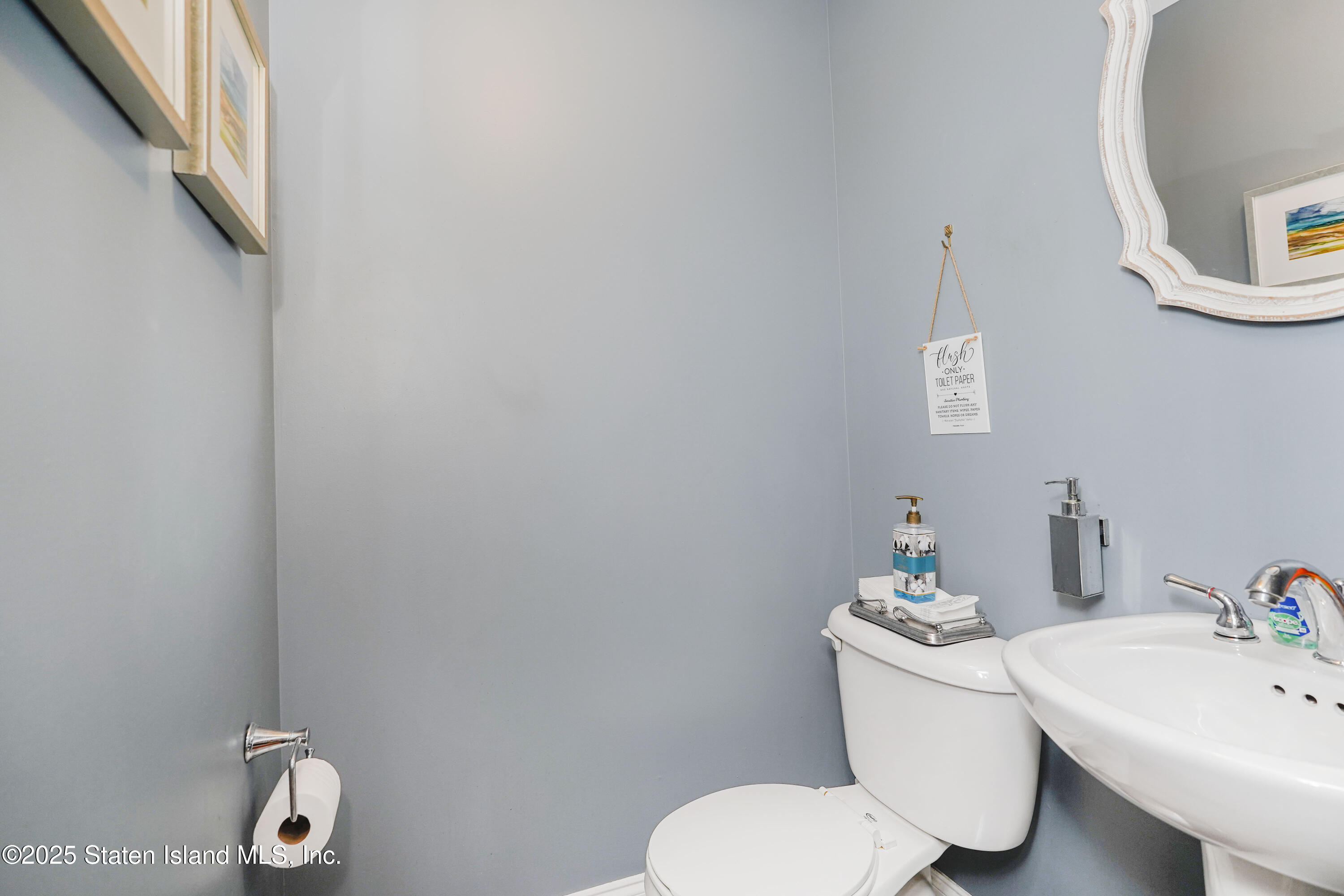 84 Presentation Circle Staten Island, NY 10312 - Photo 14 of 35 a white toilet sitting next to a bathroom sink