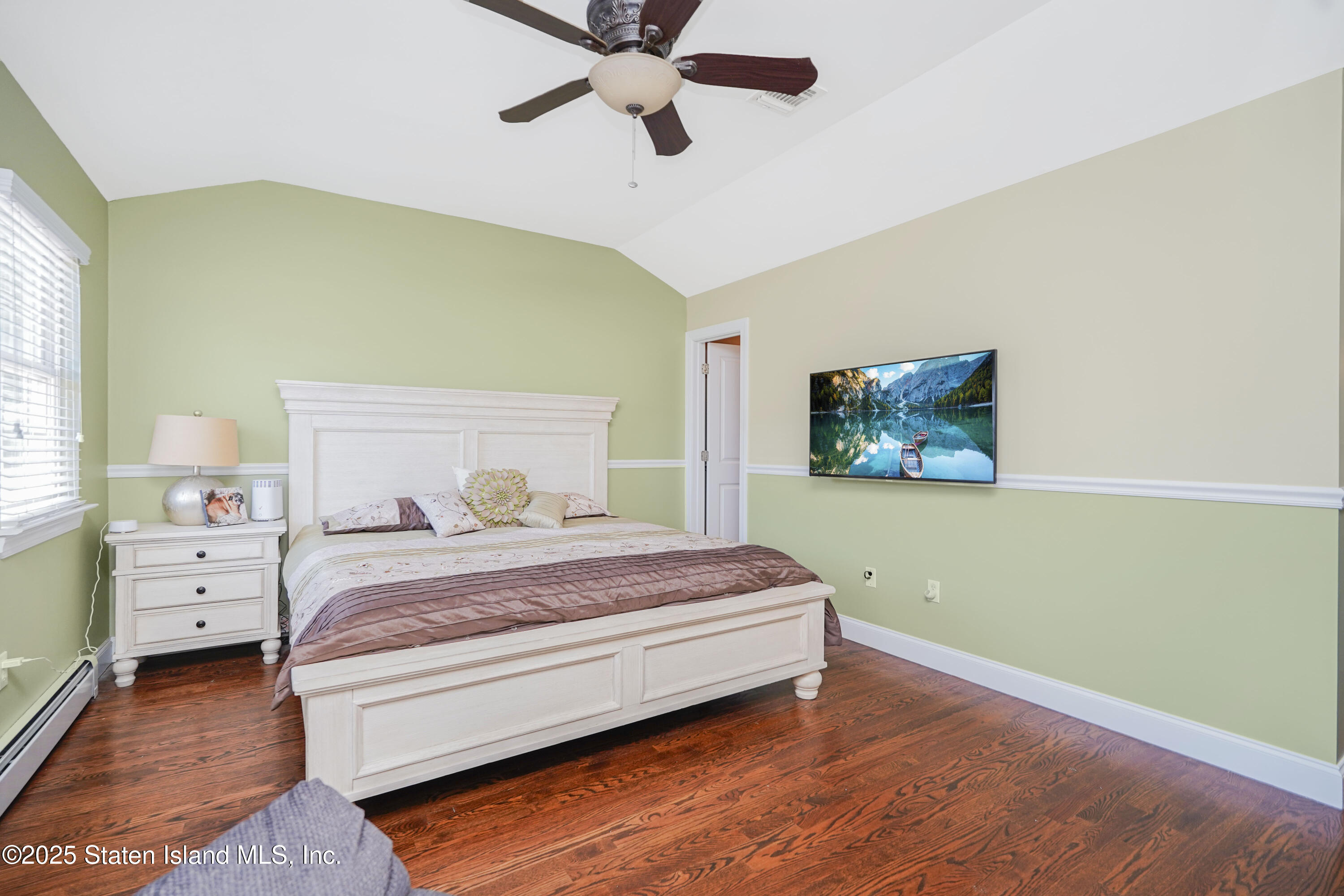 84 Presentation Circle Staten Island, NY 10312 - Photo 16 of 35 a bedroom with a bed and a ceiling fan